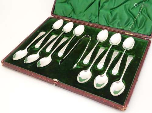 A Victorian set of 12 silver teaspoons with sugar tongs