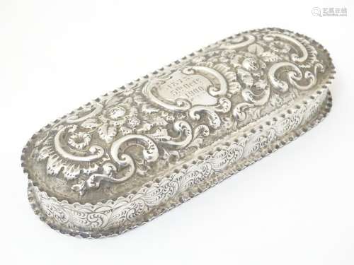 A Victorian silver dressing table box with embossed