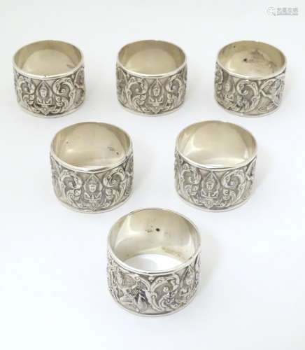 6 silver napkin rings with deity and scroll decoration