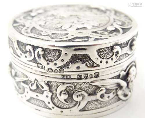 An Art Nouveau silver box of circular form with hinged