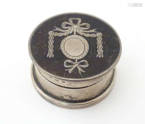 A silver pill box with pique work decoration to lid.