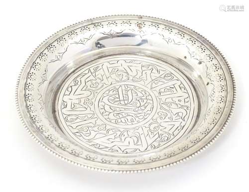 An Egyptian silver dish with engraved decoration.