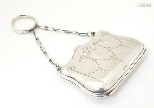 A silver purse with engraved decoration and leather