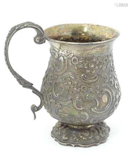 A Wm IV silver mug with embossed decoration. Hallmarked