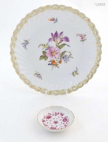 A Nymphenburg plate with a scallop edge and flower