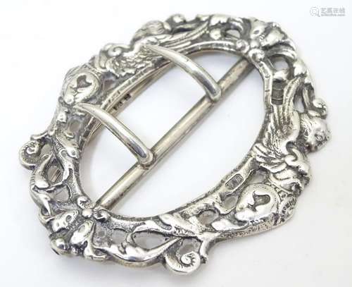 A Victorian silver buckle with cast scroll and caryatid