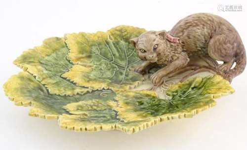 A Victorian majolica leaf plate with moulded cat