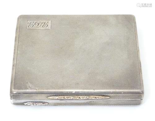 An Art Deco silver cigarette case with engine turned