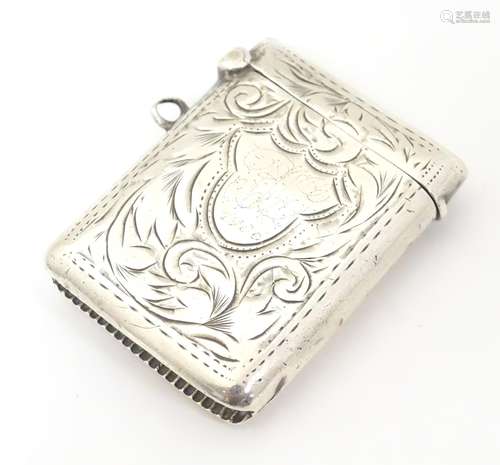 A silver vesta case with engraved decoration.