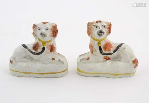 A pair of Victorian Staffordshire pottery seated