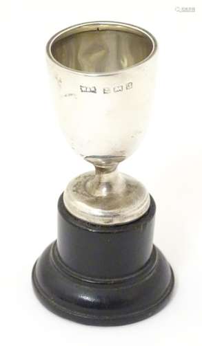 A small silver trophy cup on socle base. Hallmarked