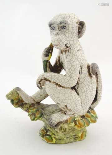 An Oriental style model of a monkey with a banana