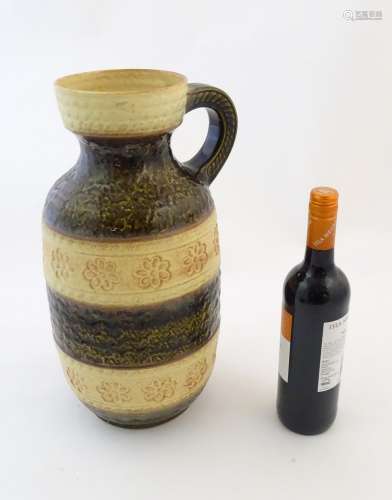 A West German vase with a mottled glaze, single handle,