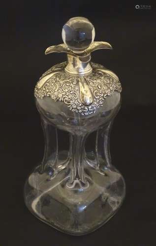 An early 20thC glass decanter with pinched waist detail