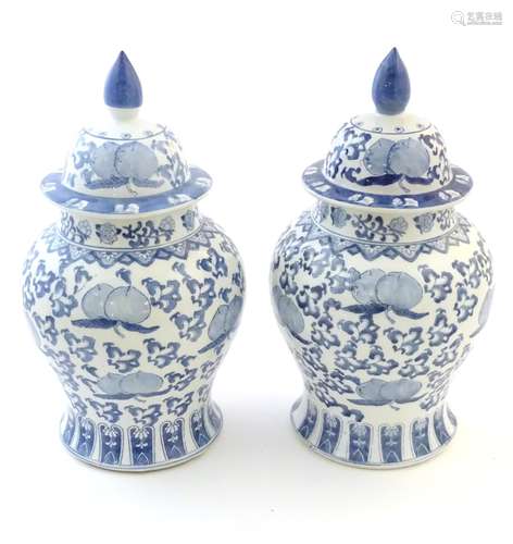 A pair of Chinese lidded vases of baluster form,