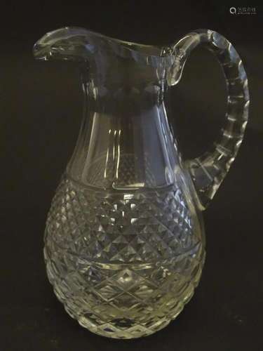 A 19thC glass jug, decorated with fluted, oval and