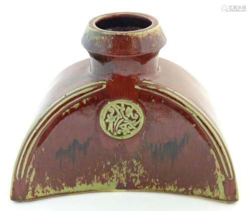 An Oriental sang de boeuf vase of shaped form with