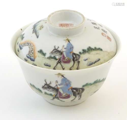 A Chinese tea bowl and cover decorated with a landscape