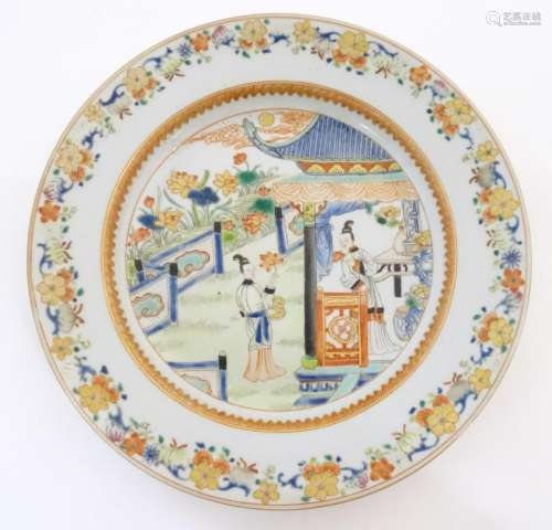 A Chinese plate depicting two ladies in a garden