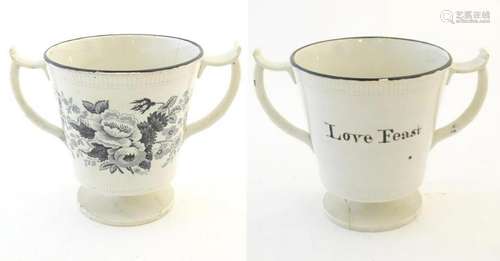 A pedestal loving cup with shaped handles, the body