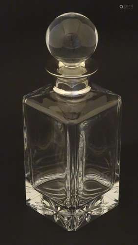 A glass decanter and stopper, the decanter with silver