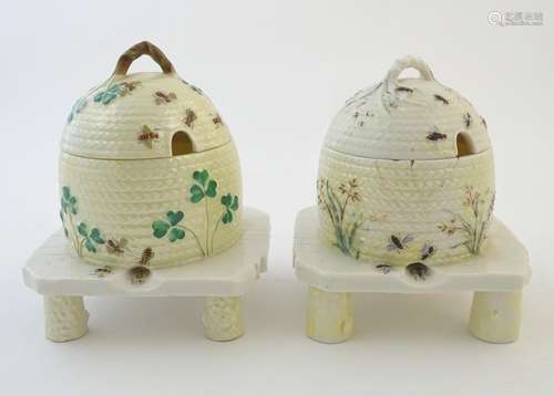 Two Belleek honey / preserve pots and covers formed as