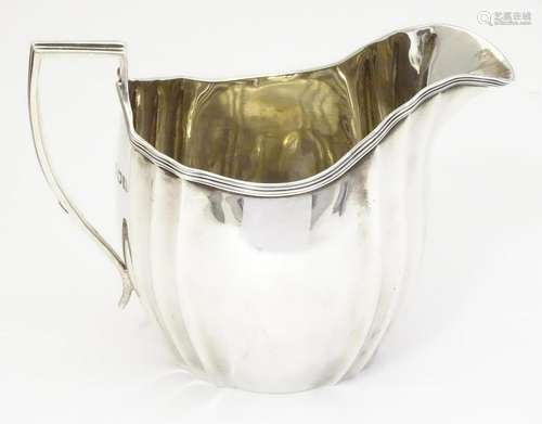 A silver cream jug, hallmarked London 1908, maker C S