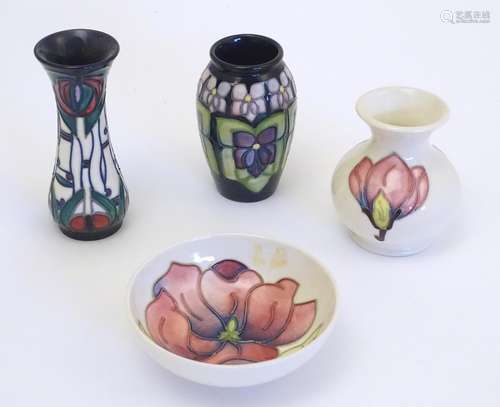 Four items of Moorcroft pottery comprising a bud vase