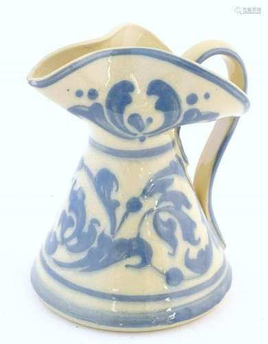 A blue and white jug of conical form with a shaped rim,