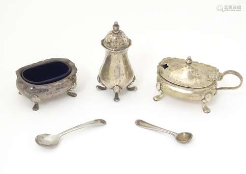 A matched silver three piece cruet set comprising salt,