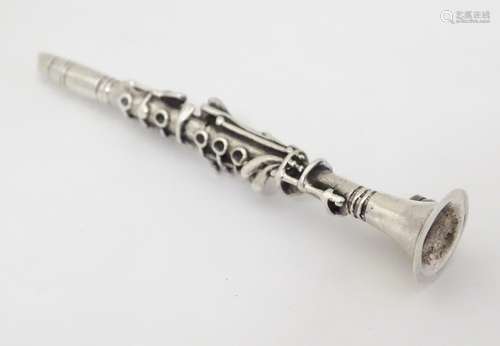 A silver brooch formed as a clarinet. Approx. 2 3/4