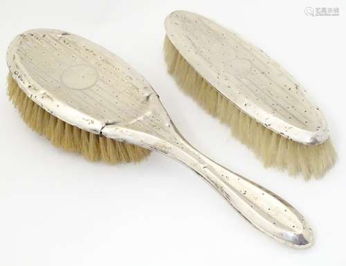 Two silver backed brushes with engine turned