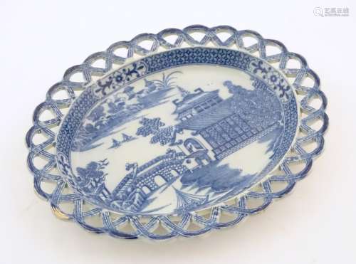 A blue and white dish of oval form with reticulated