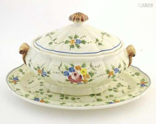 A French twin handled lidded tureen and stand with hand