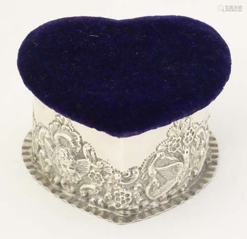 A silver trinket box of heart form with pin cushion to