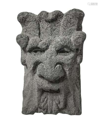 Lava stone key depicting mask