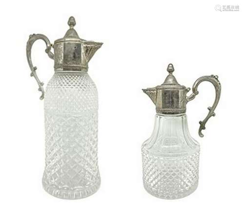 Pair of bugnate glass carafes with metal handle