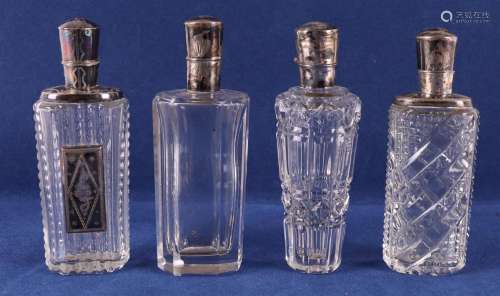 Four various cut clear crystal perfume bottles with silver f...