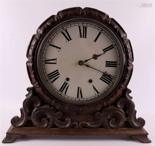 A mantel clock in a carved wooden case, late 19th century