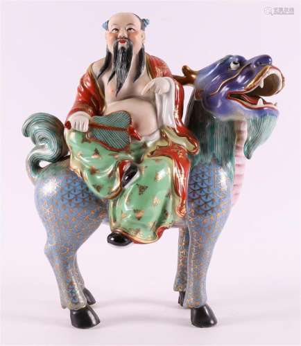 A polychrome porcelain monk on a fantasy animal, China 20th ...