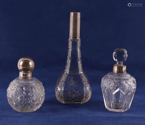Two assorted clear crystal flasks with silver mounts, early ...