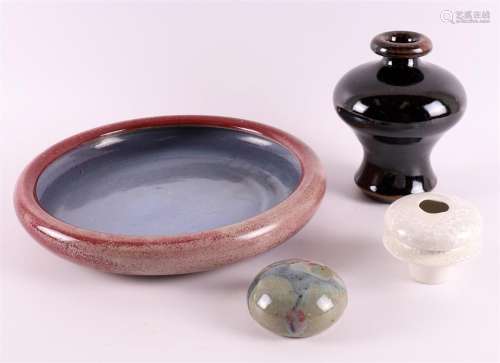 A purple glazed round earthenware bowl, signed Broekema.