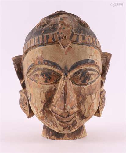 A carved wooden head of a woman, Tibet, 20th century.