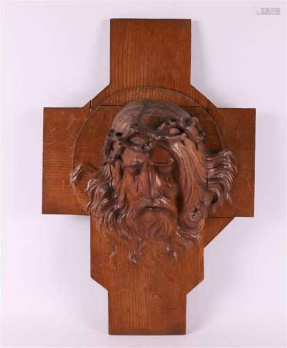 Jesus Christ with a crown of thorns on a stylized cross, aro...