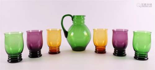 A green glass water carafe with six matching glasses, ca. 19...