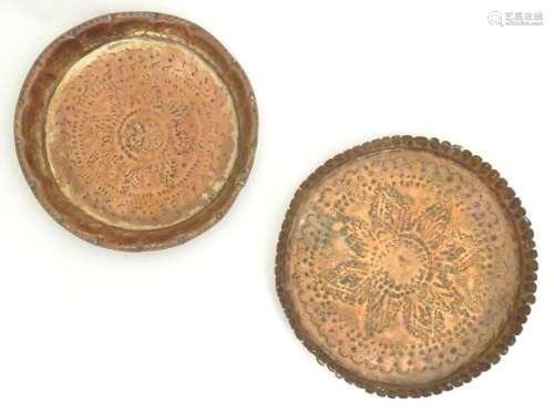 A copper dish of circular form with punchwork and hammered d...