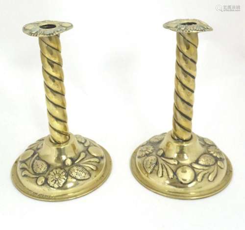 A pair of 19thC brass candlesticks with twist columns and em...