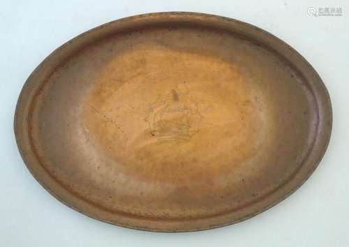 An Arts & Crafts copper tray of oval form with ship deco...