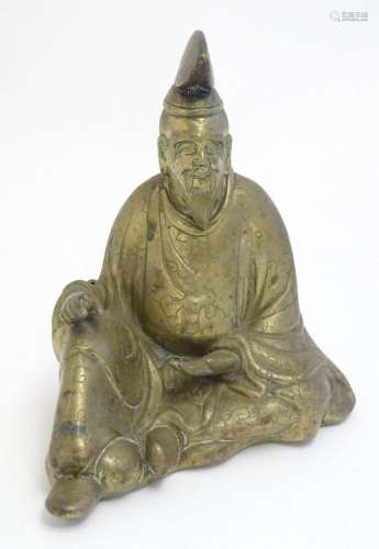 A 20thC Japanese cast model of a seated gentleman, possibly ...