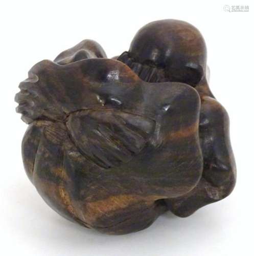A carved wooden sumo wrestler rolled in a ball. Approx. 3&qu...